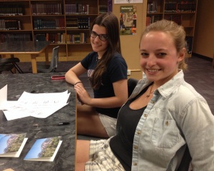 Seniors Callie Carlucci and Sarah Ellsworth write thank-you notes to Conference on World Affairs panelists in the Boulder High library during B lunch.  Both produced panels for the 2014 conference. (Photo by Jayden Simelda-Longe)